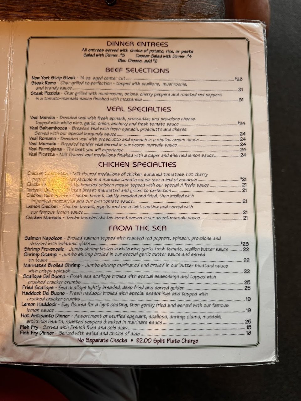 Printed menu with pasta and burger sections.